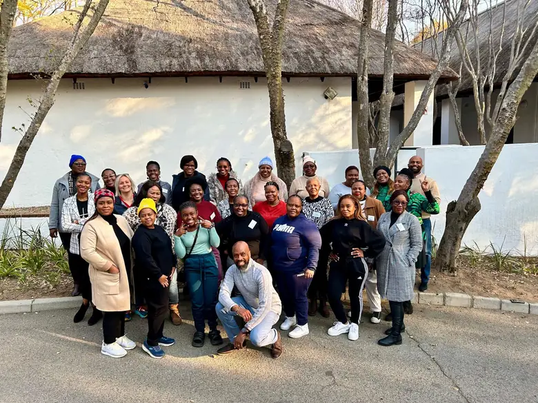 A full institutional training cohort photographed outside their in-service ultrasound course